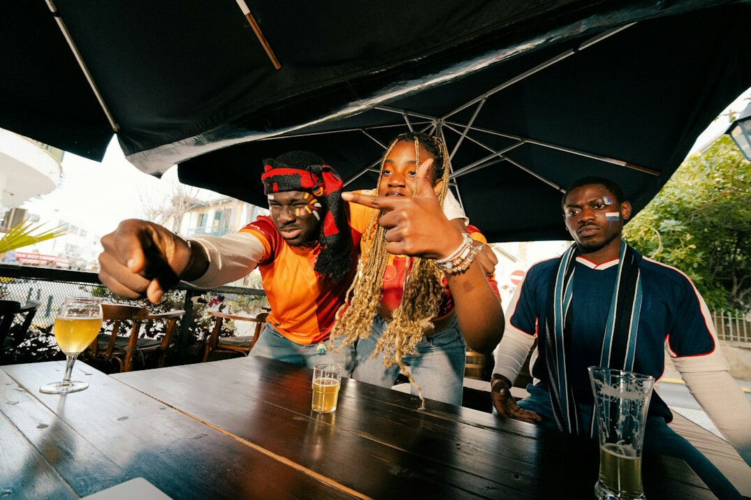 Group of friends talking and laughing together around a table