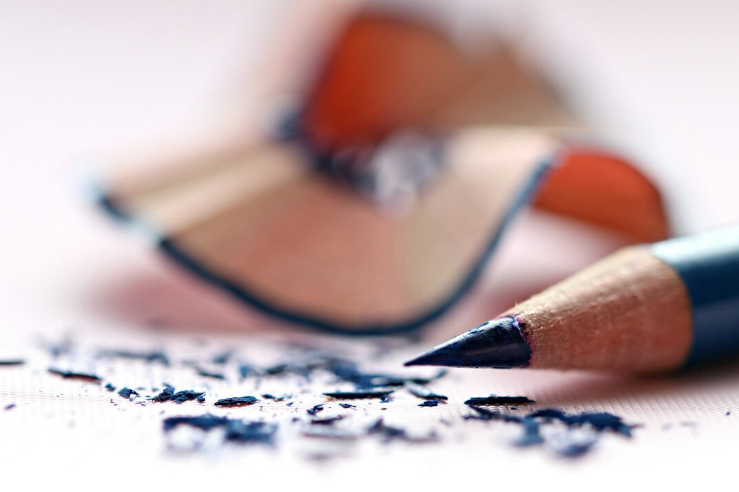 Open notebook with a pencil on a desk