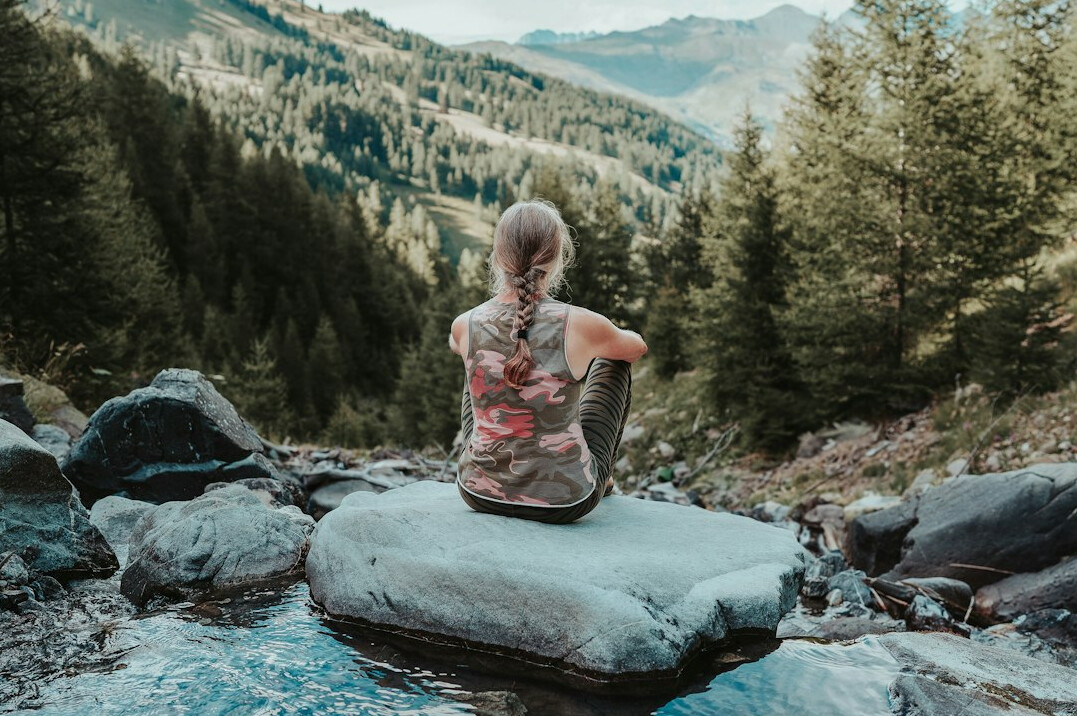 person meditating in nature