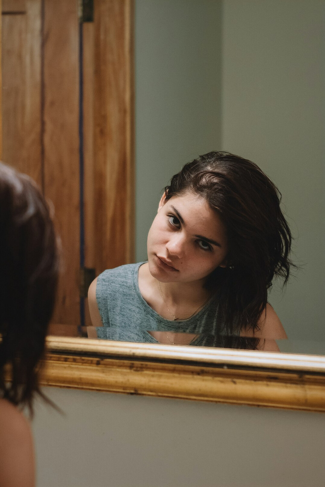 person reflecting in mirror